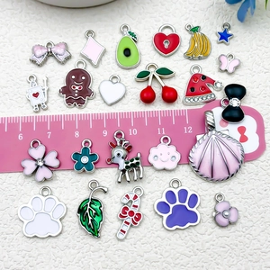 Variety of enamel fruit and holiday charms for DIY keychains with size scale