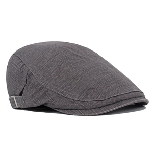 Detail of dark grey newsboy cap showing fine vertical stripes and metal adjustment buckle
