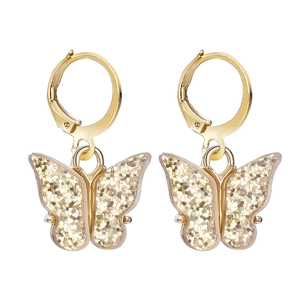 Detailed view of butterfly earrings with gold metal frame and sparkling glitter wings