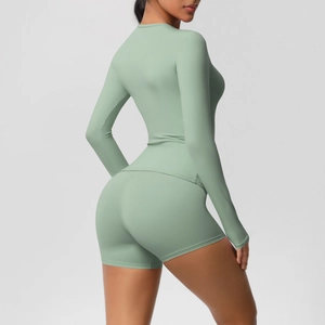 Detail view of mint green high-elastic yoga set with slim-fit long sleeves and booty shorts