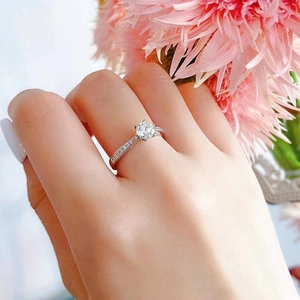 Classic silver engagement ring with six-prong set round diamond on a micro-paved band