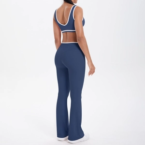 Detail view of navy blue yoga set with racerback bra and flare pants with white piping