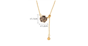 Detail showing a gold-toned Y-shaped necklace with black floral pendant and crystal inlay