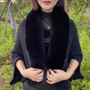 Elegant black knit poncho with fluffy faux fur collar and tassels for autumn winter warmth