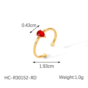 Detail showing 18k gold plated ring with red pear-cut zircon and hammered texture
