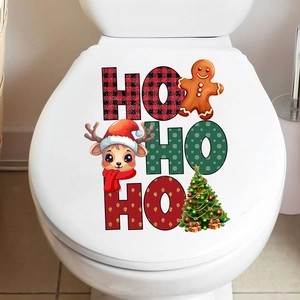 Detail of Christmas toilet lid stickers featuring Ho Ho Ho letters, reindeer, and gingerbread man