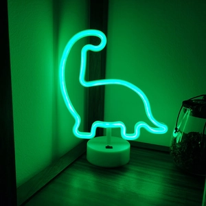 Green dinosaur LED neon sign with white base for desk decor and festive atmosphere
