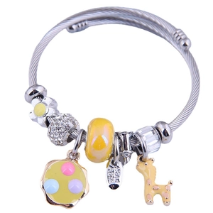 Silver twisted metal charm bracelet with yellow giraffe, floral pendants and beads