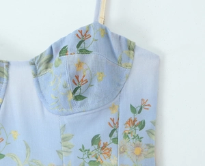 Detail of light blue floral camisole top showing textured fabric and bustier stitching
