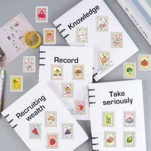 Flat lay view of cute cartoon stamp stickers with fruit and animal motifs on notebooks