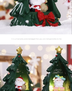 Detail of Christmas tree resin figurine with Santa inside and warm LED glowing lights