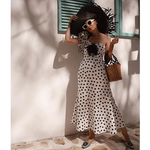 Retro white polka dot ruffled one-piece swimwear styled with large straw hat and sun hat