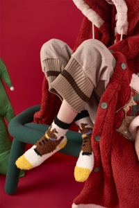 Detail of warm coral fleece Christmas socks featuring reindeer embroidery and thick plush fabric