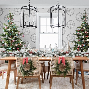 Close-up of 1.8m flocked Christmas garland with snow-dusted pine needles on dining table