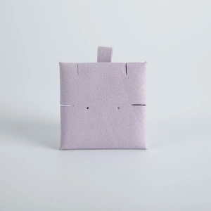 Macro detail of square light purple microfiber jewelry display card with pre-cut slots