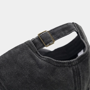 Detail of adjustable brass metal buckle on vintage washed cotton baseball cap