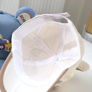 Detail of baby baseball cap interior showing breathable mesh lining and adjustable strap