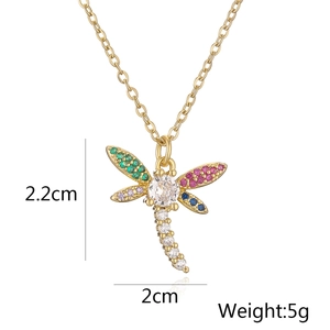 Detailed view of gold dragonfly pendant with colorful zircons showing 2.2cm height
