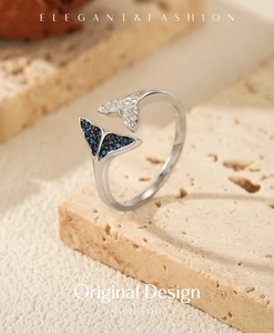 Macro detail of S925 silver mermaid tail ring with blue and white zircon stones