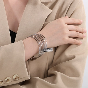Silver multi-layered stackable bangle bracelets in polished stainless steel for women