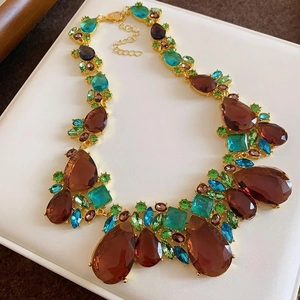 Macro detail of vintage statement necklace with colorful rhinestones on gold base