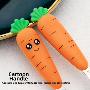 Close-up of orange carrot-shaped silicone handles for ergonomic baby silverware set