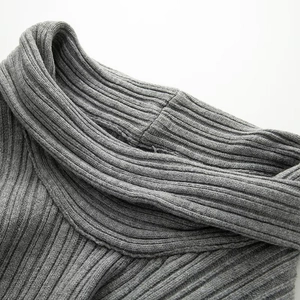 Macro shot of grey ribbed knit texture and soft turtleneck collar detail on sweater