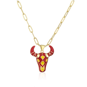 Detail of red and yellow enamel bull pendant on golden paperclip chain necklace