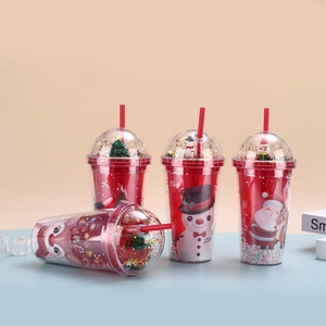Detail view of festive Christmas double-layer plastic straw cups with sequins and cartoon patterns