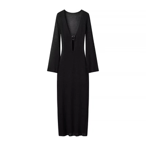 Detail shot of black knitted maxi dress with V-neckline and decorative metal ring buckle