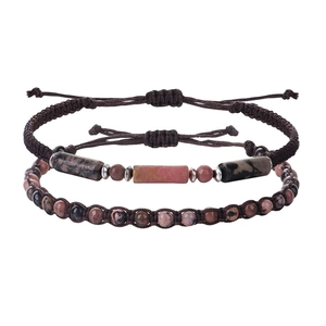 Detail view of handmade braided couple bracelets with pink spotted natural stone beads