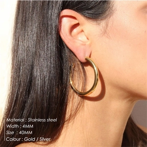 Close-up of 40mm gold stainless steel hoop earrings worn on model for a trendy look