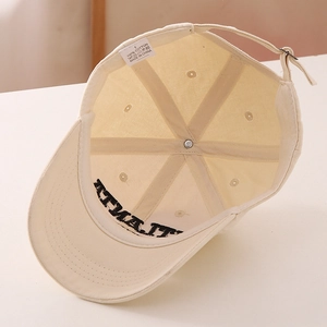 Detail of 100% cotton beige kids baseball cap with internal stitching and metal buckle