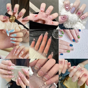 Collage of nine chic press-on nail styles including heart, floral, and animal patterns