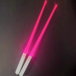 Glow-in-the-dark LED chopsticks with red light and white handle on dark background