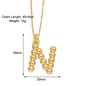 Detail view of gold letter N pendant with dimensions 29mm by 20mm and 45cm chain length