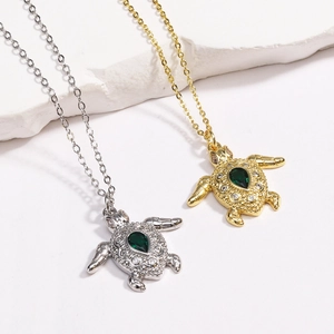 Elegant gold and silver sea turtle necklaces with green pear-shaped gemstones and crystals