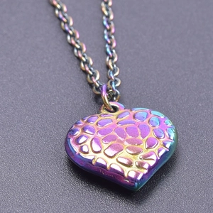 Macro shot of heart-shaped necklace with colorful iridescent finish and pebble texture