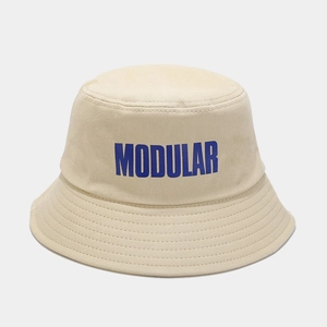 Dettaglio cappello a secchiello in tela kaki con scritta MODULAR blu e cuciture tese