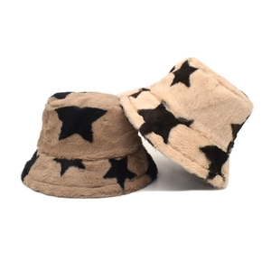 Close-up of fuzzy faux rabbit fur bucket hats with star patterns in brown and beige colors