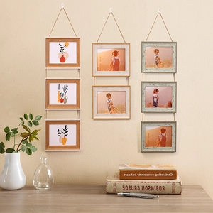 Creative rustic wood hanging picture frames with twine ropes on a beige wall