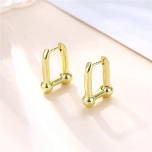 French style minimalist U-shaped gold earrings with polished metallic horseshoe design
