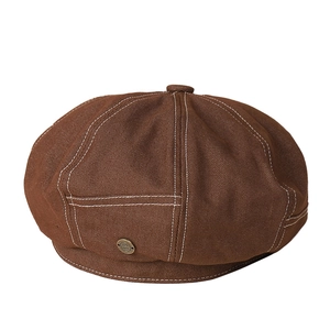 Vintage brown denim newsboy cap with white contrast stitching and metal badge detail
