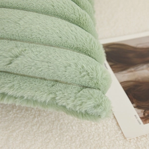 Modern plush lumbar pillow in light green with ribbed striped texture for bed decor