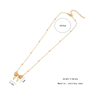 Detail view of golden stainless steel bow pendant with dimensions 2.3cm x 2cm and length specs
