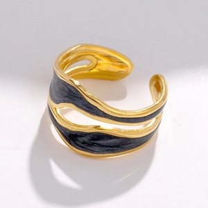 Close-up of 18K gold plated ring featuring irregular wave design and grey enamel texture