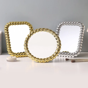 European vintage gold and silver makeup mirrors with textured spiral braided frames