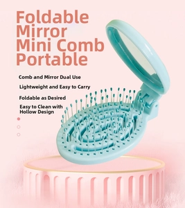 Detail of light blue foldable hair brush with integrated mirror and hollow design