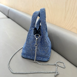 Detailed macro view of blue rhinestone evening bag with elegant silver chain strap