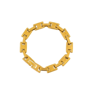 Detail of gold titanium steel bracelet with H-link chain design on white background